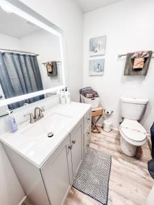 a bathroom with a white sink and a toilet at Gaslamp 2bdrm - W Parking & 4 Beds #404 in San Diego