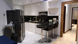 a kitchen with a black counter and a black refrigerator at Slipi Apartment 2BR in Jakarta