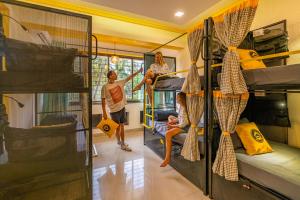 a group of people in a room with bunk beds at The Hosteller Goa, Candolim in Candolim