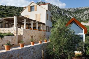 a house on the side of a mountain at Villa Vito in Hvar