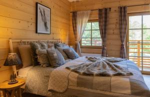a bedroom with a bed in a log cabin at Chata Dwie Doliny in Muszyna
