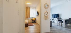 a room with a table and a dining room at AJP Nova3 Lux Apartament in Szczecin