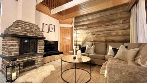 a living room with a couch and a fireplace at Nilimukka log cabin near Levi center in Levi