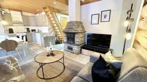 a living room with a couch and a fireplace at Nilimukka log cabin near Levi center in Levi