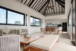 a living room with a table and a couch at Echo Beach Duo in Canggu