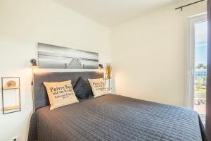 a bedroom with a bed with two pillows on it at Apartment Aurinkoranta D7 saunallinen kaksio Kalajoki in Kalajoki