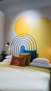 a bedroom with two beds with a painting on the wall at Fifteen Boutique Rooms Budapest with Self Check-In in Budapest