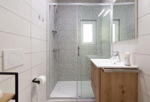 a bathroom with a shower and a sink at Walls of Piran Apartments and Rooms in Piran
