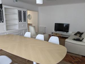 a living room with a table and a couch and a tv at Mirador de Ferradores in Betanzos