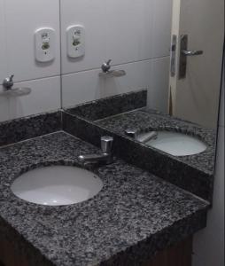 a bathroom with two sinks in a public restroom at Villa Medici lacqua II in Caldas Novas