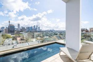 a swimming pool on a balcony with a view of the city at Stylish 2 Bed Apt +24/7 Concierge + Pool + Sauna in Sydney