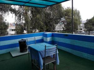 a table and two chairs on a roof with blue tiles at Jack Appart (departamento 2 cuartos y terraza) in Arequipa