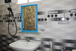 a bathroom with a sink and a mirror at White Moon Beach Resort in Trincomalee