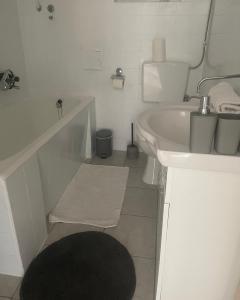 a white bathroom with a sink and a toilet at Apartmani Roko&Lovre Paklenica in Starigrad +8 photos