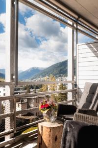 a balcony with a view of the mountains at AMERON Davos Swiss Mountain Resort in Davos