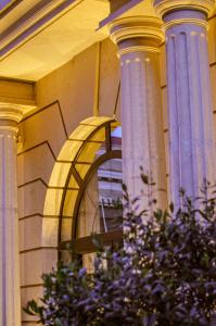 a building with two columns and a window on it at Envy Hotel in Durrës