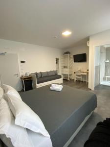 a bedroom with a large bed and a couch at Boutique Hotel Nuovo Cason in Cavallino-Treporti