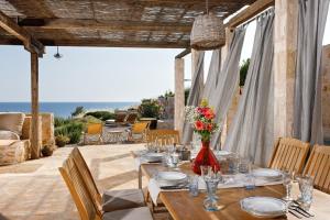 a dining room with a table with a view of the ocean at Villa Vito in Hvar