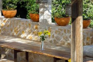 a vase of flowers sitting on a wooden table at Villa Vito in Hvar