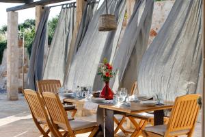 a wooden table with chairs and a vase of flowers at Villa Vito in Hvar