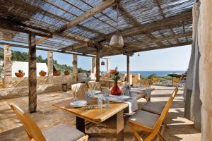 an outdoor dining area with a wooden table and chairs at Villa Vito in Hvar
