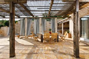 a patio with a table and chairs on a stone floor at Villa Vito in Hvar