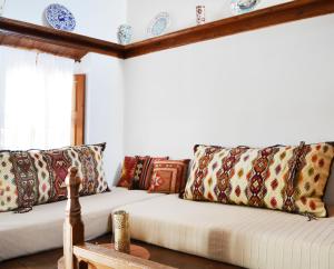 a living room with a couch with pillows at Casa Lindos in Lindos