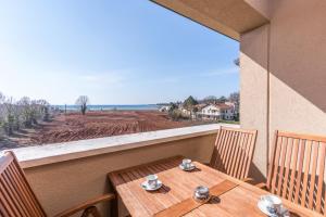 Uma mesa e cadeiras em uma varanda com vista para o oceano. em Apartment Paradiso with Sea View em Karigador