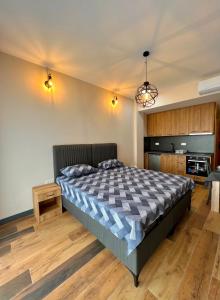 a bedroom with a large bed and a kitchen at Sea & Sky Apartments in Budva