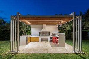 an outdoor kitchen with a pavilion in a garden at Gala's Elegant Home Villa in Zakynthos Town