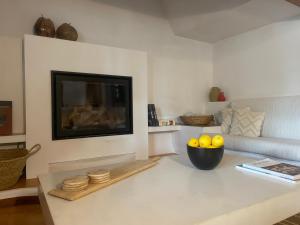 a living room with a television and a bowl of lemons at Authentic Villa with amazing pool in Santa Gertrudis de Fruitera