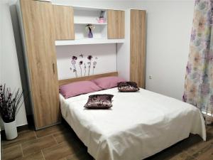 a bedroom with a bed with two pillows on it at Villa Stella in Rogoznica +46 photos