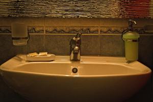 a sink with a faucet in a bathroom at Pasas Castle - Unique Luxury Apartments in Naxos Chora