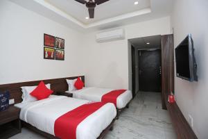 Ένα ή περισσότερα κρεβάτια σε δωμάτιο στο Super Hotel O Tulip Inn +55 φωτογραφίες