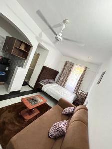 a living room with a couch and a table at Rainbow apartment in Mombasa