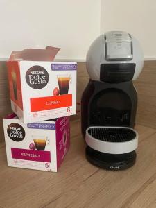 a coffee maker with a box and two boxes at Agréable gîte au coeur du centre ville 4 personnes in Chagny