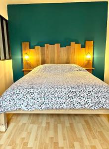 a bedroom with a bed and a green wall at Agréable gîte au coeur du centre ville 4 personnes in Chagny +14 photos