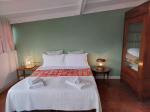 a bedroom with a bed with two towels on it at Relais Old Naples from a terrace in Naples