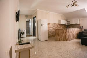 a kitchen and a living room with a refrigerator at Apartments 37B in Batumi