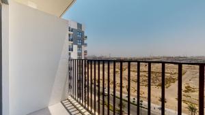 a balcony with a view of the beach at Primestay - 3BR in Wasl Gate, close to Metro Station in Dubai
