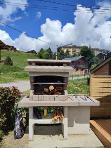 a stone outdoor oven with food inside of it at Les Gentianes, Appartement au pied des pistes in Saint-Pierre-dels-Forcats