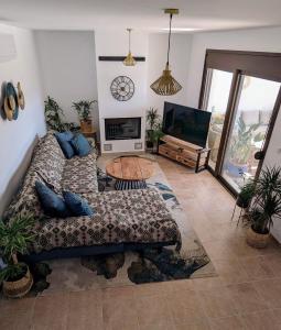 a living room with a couch and a flat screen tv at Casa Christiana, Lardos in Lardos