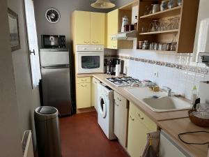 a kitchen with a sink and a stove top oven at Le Mans Kleber in Le Mans