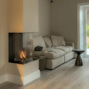 a living room with a couch and a fireplace at Wenning35 in Wenningstedt