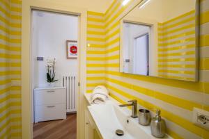 a yellow and white bathroom with a sink and a mirror at Sea View Luxury Apartment in Castellammare di Stabia +52 photos