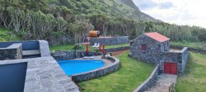an aerial view of a backyard with a swimming pool at Kuanza Nature Experience, Fajã do Belo in Fajã da Caldeira de Santo Cristo