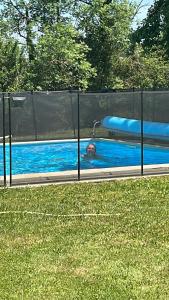 a man is in a swimming pool with aqual at Domaine Manon in Buzon