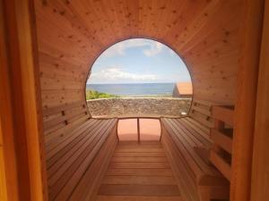 a window in a sauna with a view of the ocean at Kuanza Nature Experience, Fajã do Belo in Fajã da Caldeira de Santo Cristo