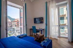a bedroom with a blue bed and a large window at Sea View Luxury Apartment in Castellammare di Stabia