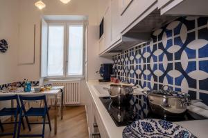 a kitchen with blue and white tiles on the wall at Sea View Luxury Apartment in Castellammare di Stabia
